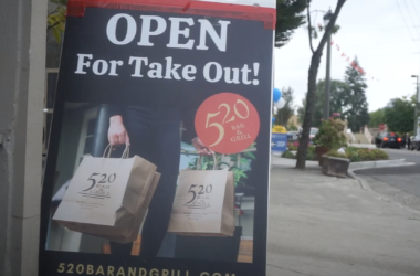 Sign showing restaurant is open for take-out