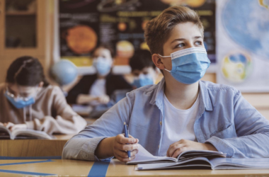 Student studying while wearing a surgical mask