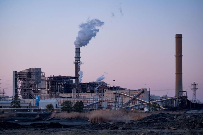 smoke coming from a smokestack at a power plant